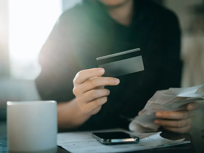 person holding a debit card